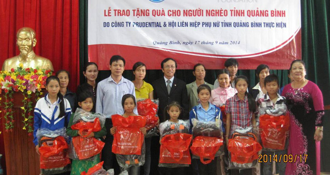 Đại diện Công ty Bảo hiểm Nhân thọ Prudential Việt Nam tại Quảng Bình trao quà cho trẻ em và phụ nữ nghèo huyện Quảng Trạch.