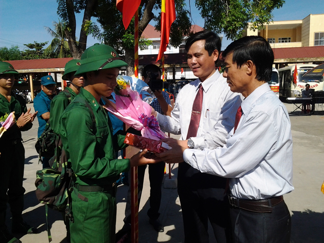Các đồng chí lãnh đạo thị xã Ba Đồn tặng hoa, quà và chúc mừng các tân binh lên đường nhập ngũ.