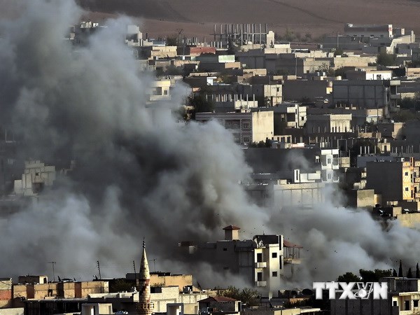Khói bốc lên sau cuộc không kích của liên quân do Mỹ dẫn đầu vào các mục tiêu của IS ở Kobane ngày 13-10. AFP/(Nguồn: TTXVN)