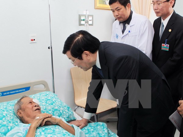 Chủ tịch nước Trương Tấn Sang thăm hỏi bệnh nhân đang điều trị tại Bệnh viện Chợ Rẫy-Phnom Penh. (Ảnh: Nguyễn Khang/TTXVN)