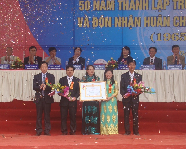 Đồng chí Nguyễn Tiến Hoàng, TUV, Phó Chủ tịch UBND tỉnh trao Huân chương Lao động hạng Nhì cho tập thể giáo viên, học sinh Trường THPT số 1 Bố Trạch.