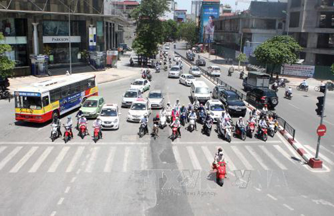 Dừng lại đèn đỏ là một cực hình với người tham gia giao thông trong những ngày nắng nóng. Ảnh: Minh Quyết – TTXVN