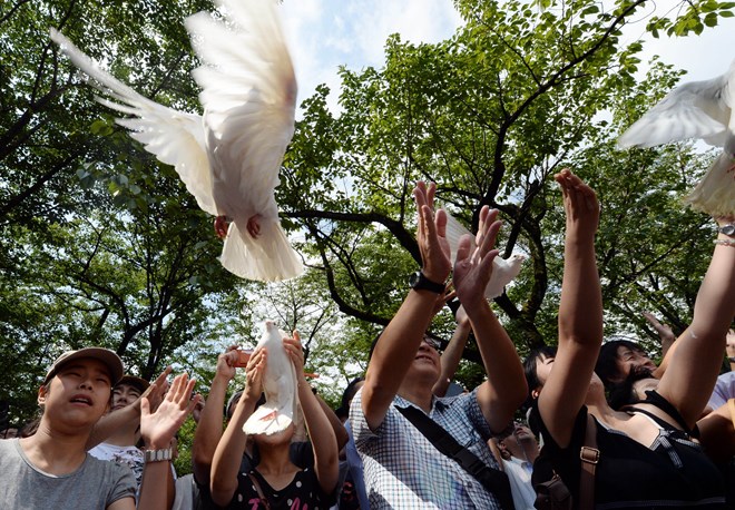 Người dân Nhật Bản thả chim bồ câu, mong ước một thế giới hòa bình. (Ảnh: Kyodo/TTXVN)