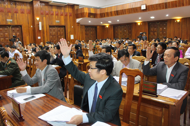 Các đại biểu tham dự kỳ họp thứ 16, HĐND tỉnh khóa XVI biểu quyết thông qua Nghị quyết về dự toán thu, chi ngân sách Nhà nước năm 2016.