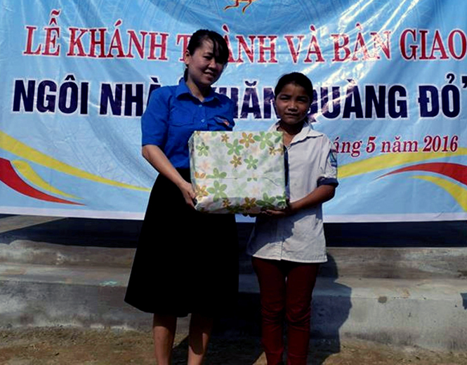Chị Nguyễn Thị Minh, Chủ tịch Hội đồng Đội tỉnh trao quà cho em Hồ Thị An, Trường Tiểu học và THCS Kim Thủy 1(huyện Lệ Thủy).
