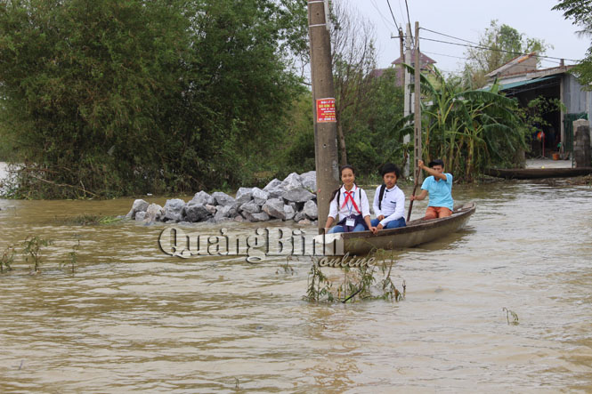 Học sinh cấp II ở thôn Vinh Quang đến trường bằng thuyền khi lũ chưa rút.
