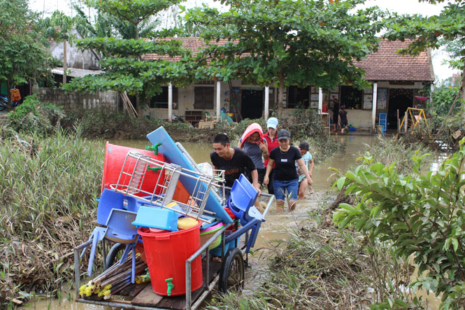 Giáo viên Trường mầm non Sơn Thủy vận chuyển dụng cụ dạy học đến địa điểm vệ sinh do trường vẫn bị ngập lụt.