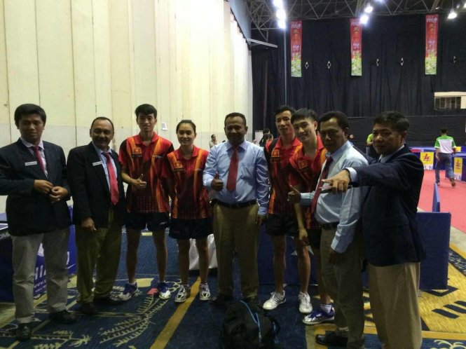 Nguyễn Anh Tú (áo đỏ thứ ba từ phải sang) chụp ảnh cùng các trọng tài quốc tế và đội tuyển bóng bàn VN sau khi giành HCV. Ảnh: NGUYỄN HÙNG