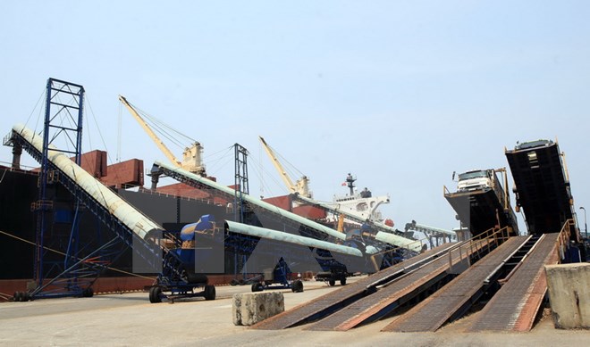 Bốc xếp gỗ dăm tại cảng Dung Quất. (Ảnh: Huy Hùng/TTXVN)