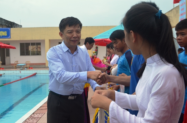 Đồng chí Nguyễn Hữu Hoài, Phó Bí thư Tỉnh ủy, Chủ tịch UBND tỉnh tặng cờ lưu niệm cho các đoàn VĐV