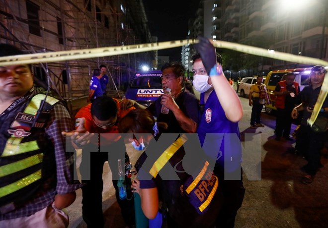 Sơ cứu người dân (thứ hai, phải) bị thương trong vụ khu nghỉ dưỡng Resort World Manila ở Manila bị tấn công ngày 2-6. (Nguồn: EPA/TTXVN)