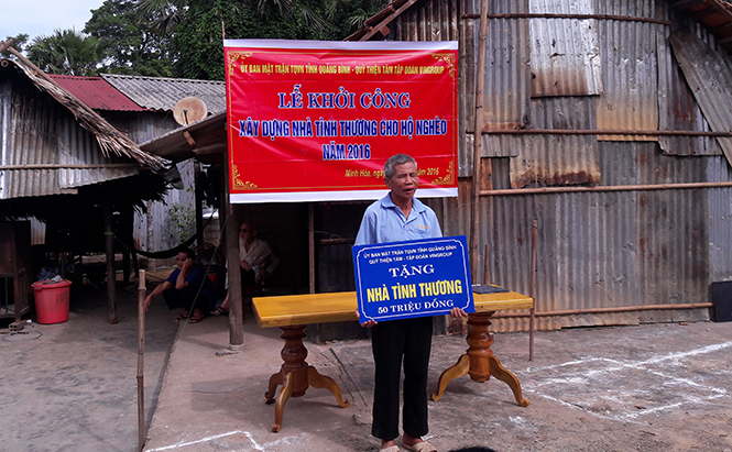 Ủy ban Mặt trận Tổ quốc Việt Nam huyện Minh Hóa trao tiền hỗ trợ nhà cho một người dân huyện Minh Hóa.