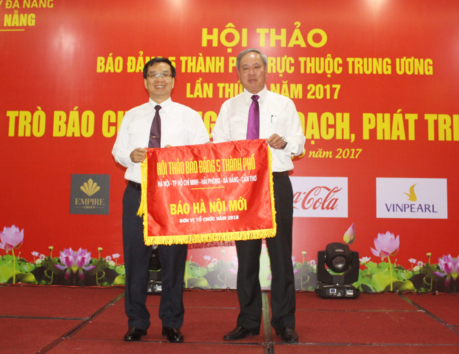 Đại diện Báo Đà Nẵng trao cờ luân phiên đăng cai tổ chức hội thảo báo Đảng 5 thành phố trực thuộc Trung ương lần thứ 7 năm 2018 cho Báo Hà Nội mới.