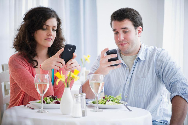 Dùng smartphone trên bàn ăn ảnh hưởng đến việc tương tác xã hội - Ảnh: Getty
