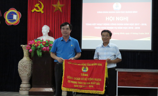 Đồng chí Nguyễn Lương Bình, Tỉnh uỷ viên, Chủ tịch LĐLĐ tỉnh tặng Cờ thi đua cho CĐCS Trường THPT Kỹ thuật Lệ Thuỷ.