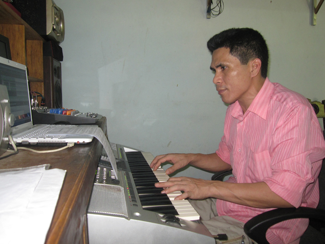 Nguyễn Minh Tám bên cây đàn.