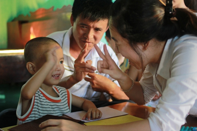 Chủ tịch CLB người điếc Quảng Bình Phạm Thị Minh Trang dạy ngôn ngữ ký hiệu cho trẻ câm điếc