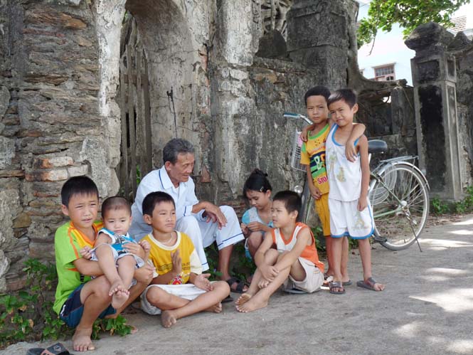 Các cháu say sưa ngồi nghe ông kể chuyện ngày xưa. Ảnh: P.V