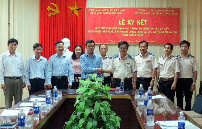 Đại diện lãnh đạo Ngân hàng Nhà nước chi nhánh tỉnh Quảng Bình và Cục Thi hành án dân sự tỉnh ký kết quy chế phối hợp.