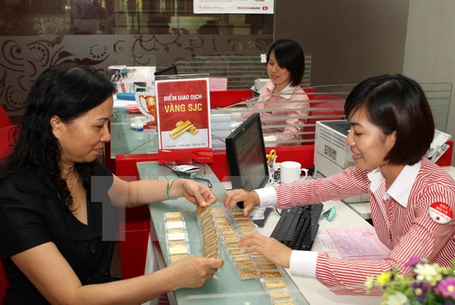 Khách giao dịch mua vàng tại Hội sở Techcombank tại Hà Nội. (Ảnh: Trần Việt/TTXVN)