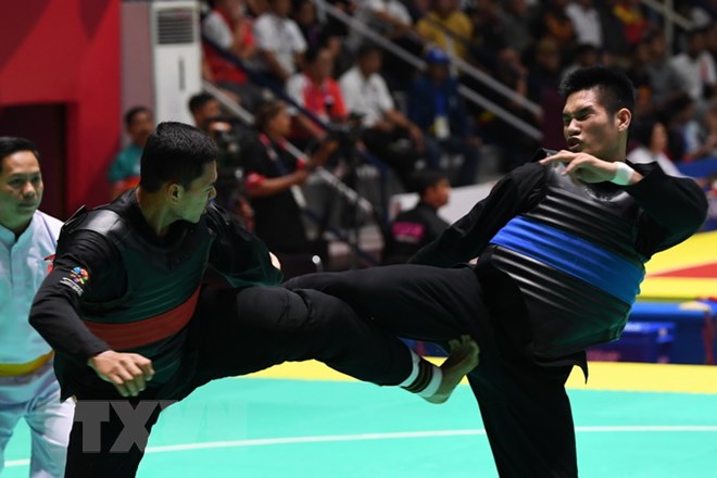 Vận động viên Nguyễn Duy Tuyến (phải) tranh tài với vận động viên Aji Bangkit Pamungka (trái) của Indonesia ở nội dung Pencak Silat hạng cân 85-90kg dành cho nam tại ASIAD 2018 diễn ra ở Jakarta, Indonesia ngày 26-8. (Nguồn: AFP/TTXVN)