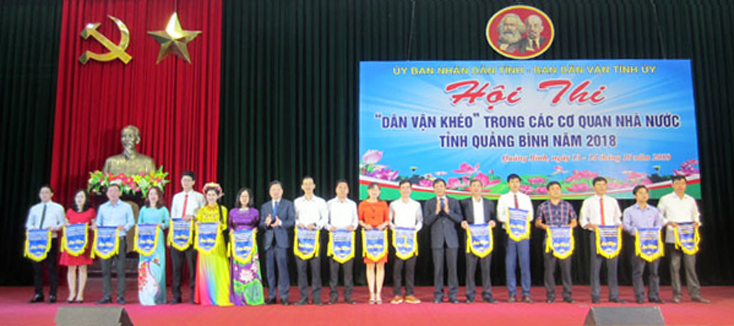 Đồng chí Nguyễn Tiến Hoàng, Phó Chủ tịch UBND tỉnh; Nguyễn Công Huấn, Trưởng Ban Dân vận Tỉnh ủy trao cờ lưu niệm cho các đội thi
