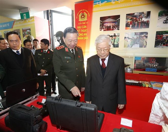Tổng Bí thư, Chủ tịch nước Nguyễn Phú Trọng xem một số trang thiết bị của Lực lượng Công an nhân dân trưng bày tại Hội nghị. (Ảnh: Trí Dũng/TTXVN)