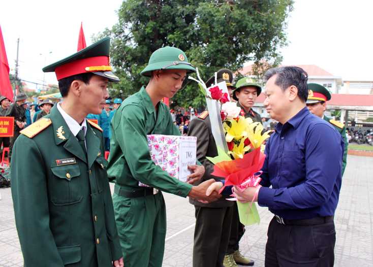 Đồng chí Nguyễn Tiến Hoàng, Phó Chủ tịch UBND tỉnh tặng hoa và quà cho các tân binh trong lễ giao nhận quân.