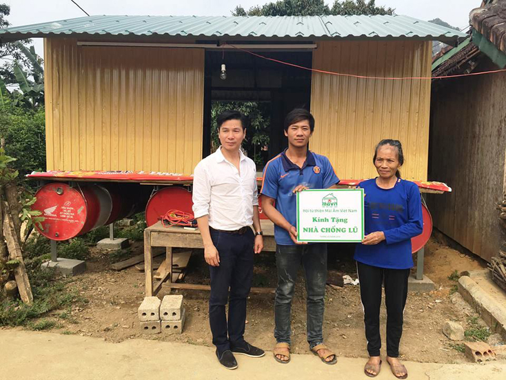 Gia đình chị Cao Thị Hóa vui mừng nhận tiền hỗ trợ xây nhà phao tránh lũ.