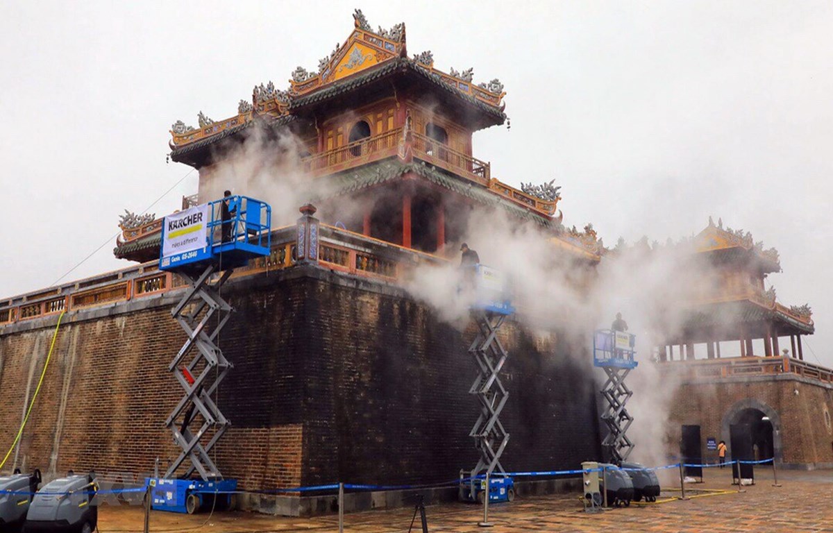 Các chuyên gia Karcher làm sạch di tích cổng Ngọ Môn, Đại nội Huế bằng công nghệ hơi nước nóng. (Ảnh: Quốc Việt/TTXVN)