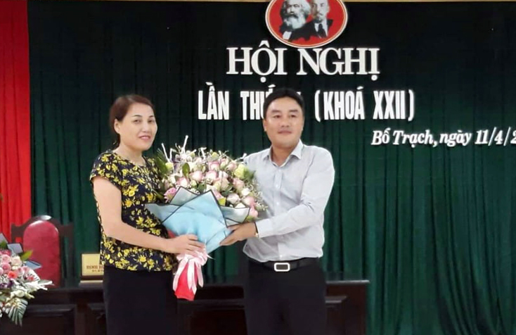 Đồng chí Bí thư Huyện ủy Bố Trạch Đinh Hữu Thành tặng hoa chúc mừng đồng chí Phạm Thị Hồng Tứ.