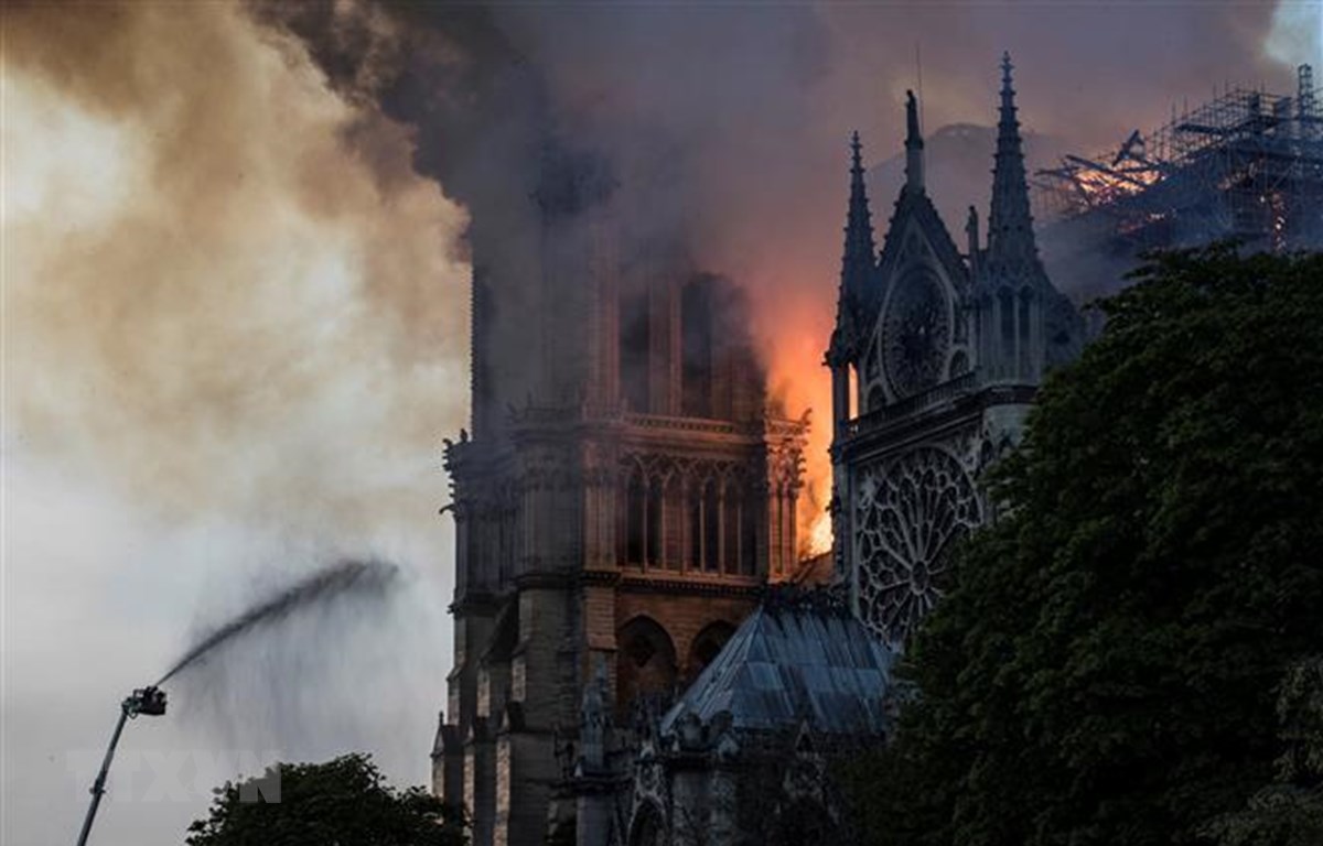 Lửa khói bốc lên dữ dội trên nóc nhà thờ Đức Bà ở Paris, Pháp ngày 15-4-2019. (Ảnh: AFP/TTXVN)