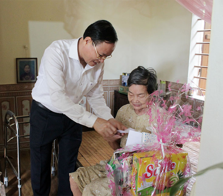 đồng chí Lê Minh Ngân, TUV, Phó Chủ tịch UBND tỉnh tặng quà cho bà Trần Thị Nghị, vợ liệt sỹ Nguyễn Ngọc Mậu ở Quảng Liên, Quảng Trạch
