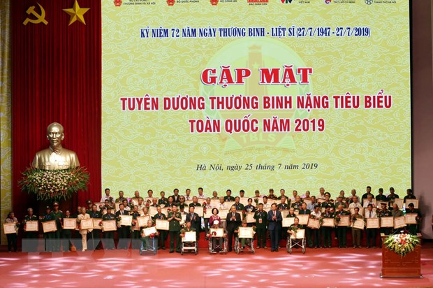  Thủ tướng Nguyễn Xuân Phúc tặng quà cho các đại biểu thương binh nặng được tuyên dương. (Ảnh: Anh Tuấn/TTXVN)