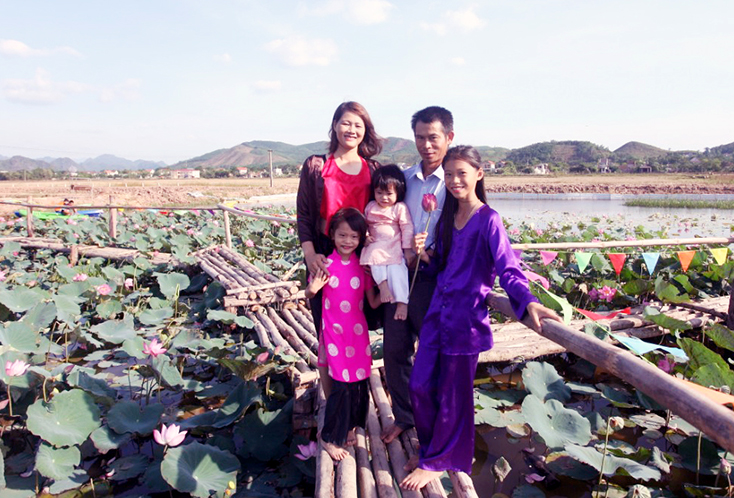 Chủ nhân Nguyễn Minh Tuấn cùng gia đình bên đầm sen ở thôn 1 Cù Lạc, xã Sơn Trạch.