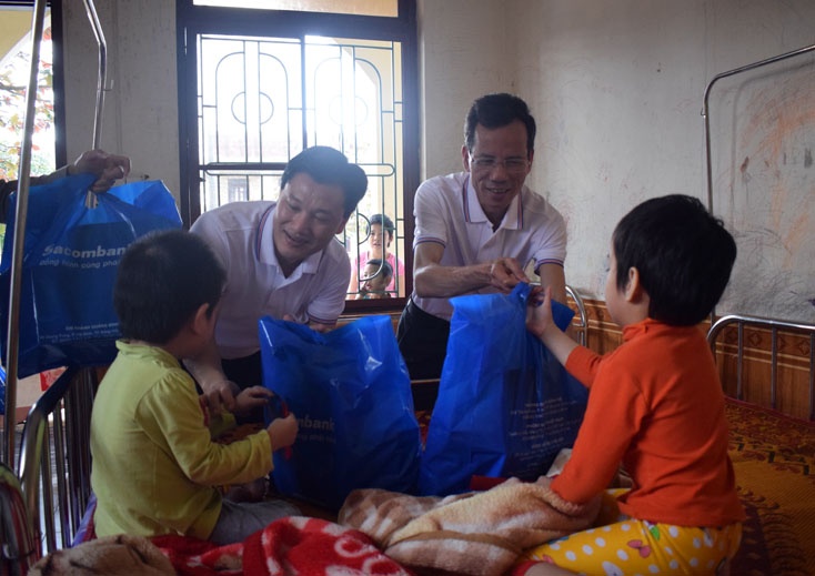 Đại diện lãnh đạo đơn vị trực tiếp trao quà cho em nhỏ đang được chăm sóc, nuôi dưỡng tại Trung tâm