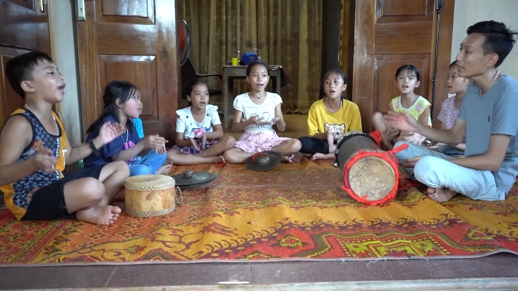 Việt Anh cùng các bạn nhỏ trong xã học hát dân ca.