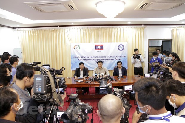  Thứ trưởng Bộ Y tế Lào (giữa), ông Phouthone Meuangpak, thông báo về những ca nhiễm COVID-19 đầu tiên tại nước này. (Ảnh: Phạm Kiên/Vietnam+)