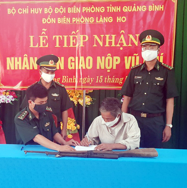 Ông Hồ Văn Hiền ký biên bản và giao nộp vũ khí.