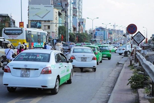 Xe taxi hay xe chạy ứng dụng Grab, Be phải chuyển đổi biển kiểm soát từ màu trắng sang màu vàng theo Thông tư mới của Bộ Công an. (Ảnh: Minh Sơn/Vietnam+)
