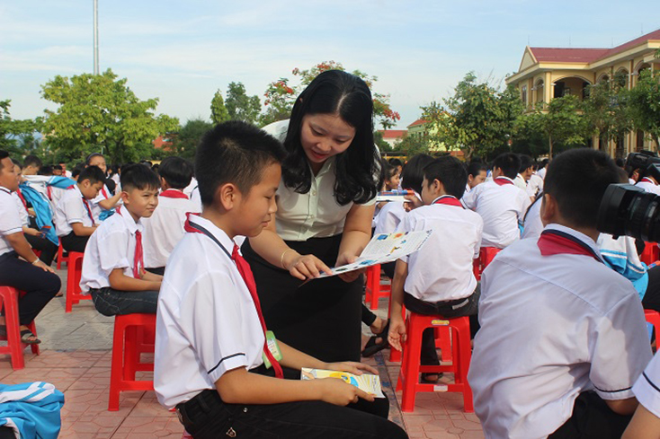 Cán bộ PC Quảng Bình tuyên truyền, hướng dẫn thực hiện tiết kiệm điện trong trường học. 