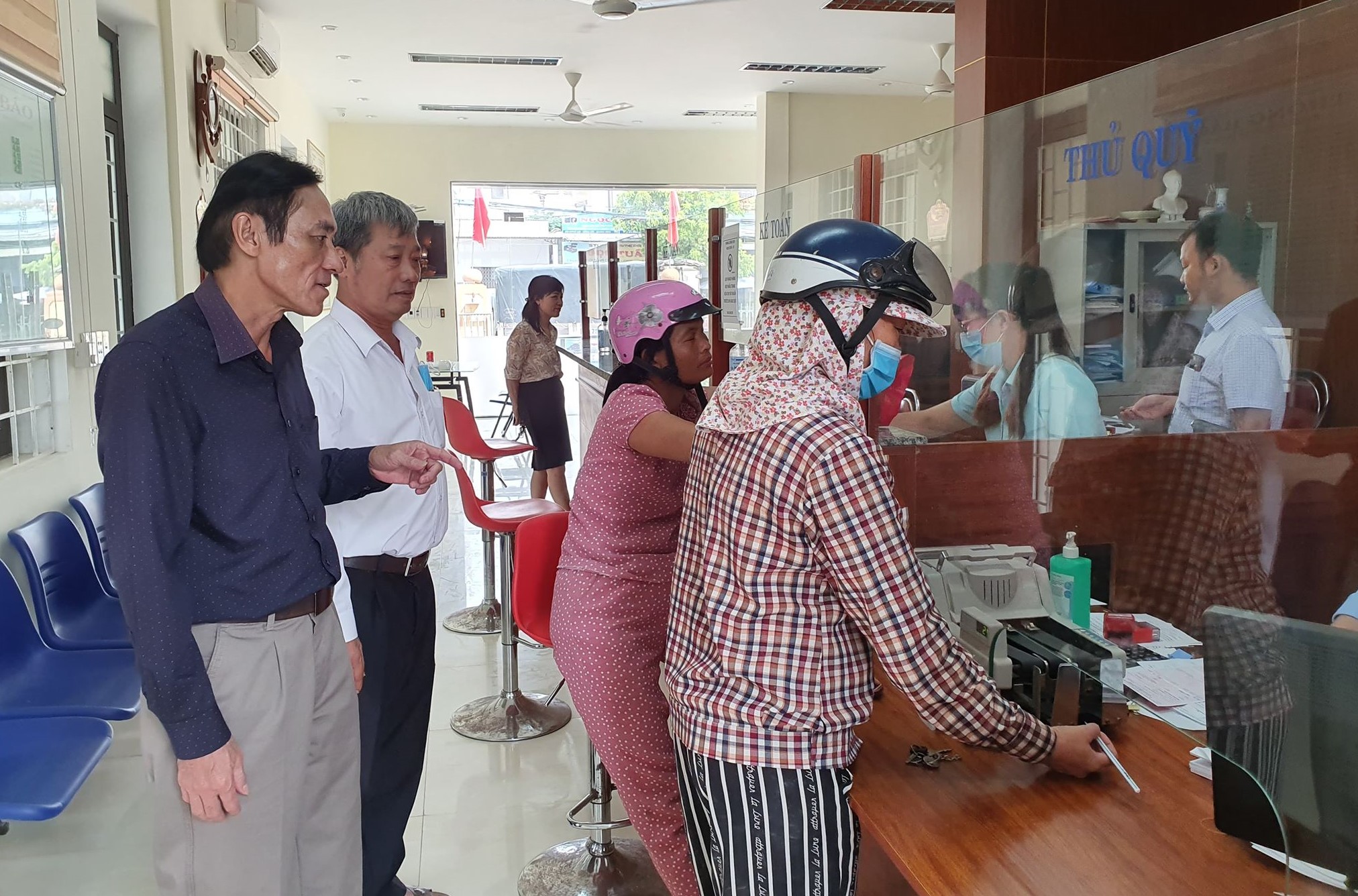    Ông Ngô Gia Thởi (ngoài cùng bên trái) đang đi thăm HTX Quỹ tín dụng xã Đức Ninh, thành phố Đồng Hới. 