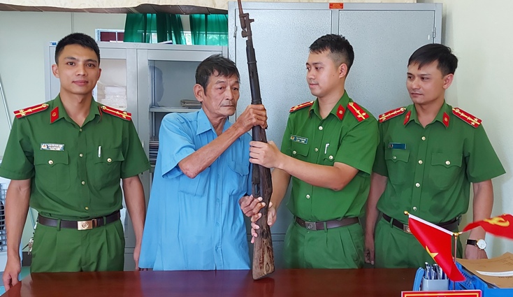 Ông Phạm Bá Dung giao nộp khẩu súng quân dụng cho Công an xã Phong Hóa.