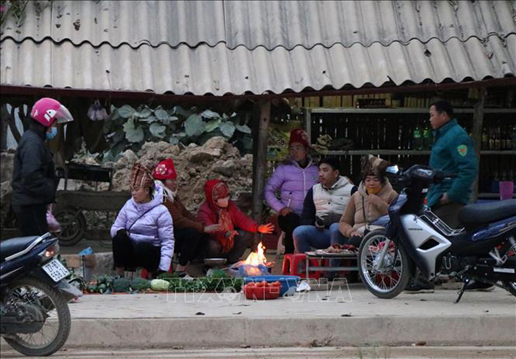  Tại phường Thanh Trường (thành phố Điện Biên Phủ), nhiều tiểu thương tụ tập tại điểm chợ cóc sưởi ấm bên đống lửa. Ảnh: Xuân Tiến-TTXVN