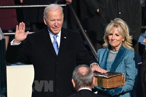  Ông Joe Biden (trái) tuyên thệ nhậm chức trước Chánh án Tòa án Tối cao John Roberts tại Đồi Capitol ở thủ đô Washington DC., ngày 20-1. (Ảnh: AFP/TTXVN)