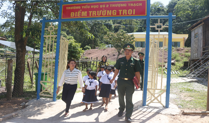 BĐBP Đồn Biên phòng Cửa khẩu Cà Roòng và các thầy cô đưa các em học sinh lên cột mốc quốc giới.