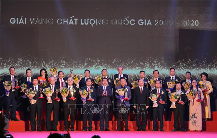 Bộ trưởng Bộ Khoa học và Công nghệ Huỳnh Thành Đạt (bên phải) và Bộ trưởng Bộ Công Thương Nguyễn Hồng Diên trao giải Vàng Chất lượng Quốc gia cho các doanh nghiệp. Ảnh: Hoàng Hiếu/TTXVN
