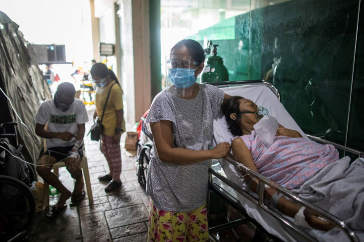 Các bệnh nhân được điều trị bên ngoài một bệnh viện công ở thành phố Quezon, nơi vừa thông báo tình trạng quá tải ngày 26-4. Ảnh: Reuters