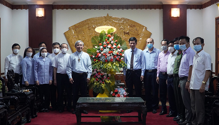 Giám mục Nguyễn Anh Tuấn tặng hoa chúc mừng và chụp ảnh lưu niệm cùng đồng chí Phó Chủ tịch UBND tỉnh Hồ An Phong cùng các thành viên.