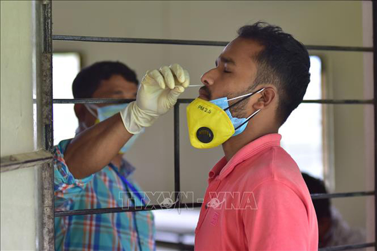 Nhân viên y tế lấy mẫu xét nghiệm COVID-19 cho người dân tại Assam, Ấn Độ. Ảnh: THX/TTXVN
